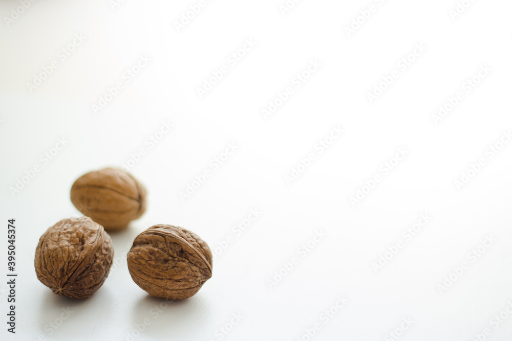 Close up of three walnuts on white background; isolated Close up of three walnuts on white background; isolated
