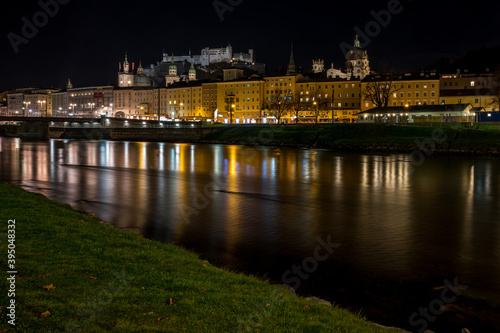city of salzburg with castle at night at river salzach