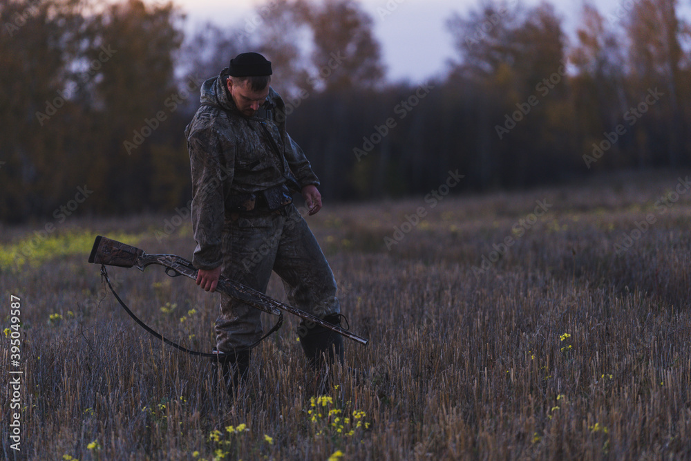 Male hunter in camouflage clothes ready to hunt with hunting rifle Male hunter in camouflage clothes ready to hunt with hunting rifle
