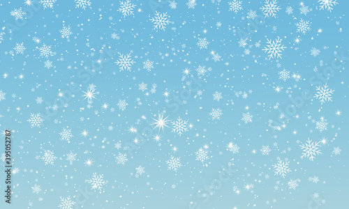 Snow background. Winter snowfall. White snowflakes on blue sky. Christmas background. Falling snow.