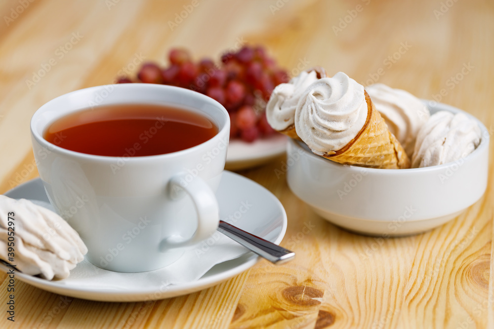 Tea mug with cake on Christmas holiday table selective focus background blurred. Tea mug with cake on Christmas holiday table selective focus background blurred.