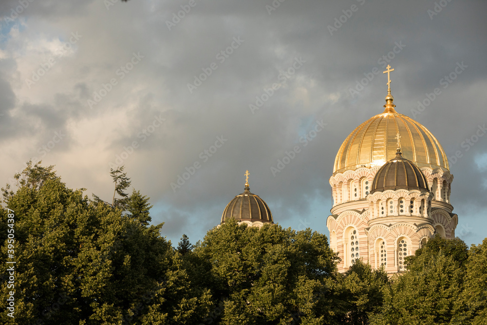 Orthodox church with a gold plated roof during golden hour