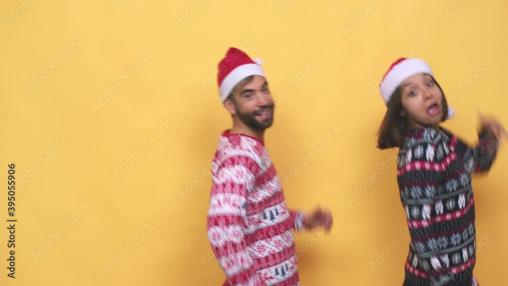 Young mixed race couple celebrating christmas day dancing isolated Young mixed race couple celebrating christmas day dancing isolated