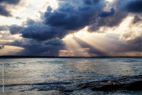 Sun rays breaking through the clouds over the Mediterranean Sea in Formentera, Spain