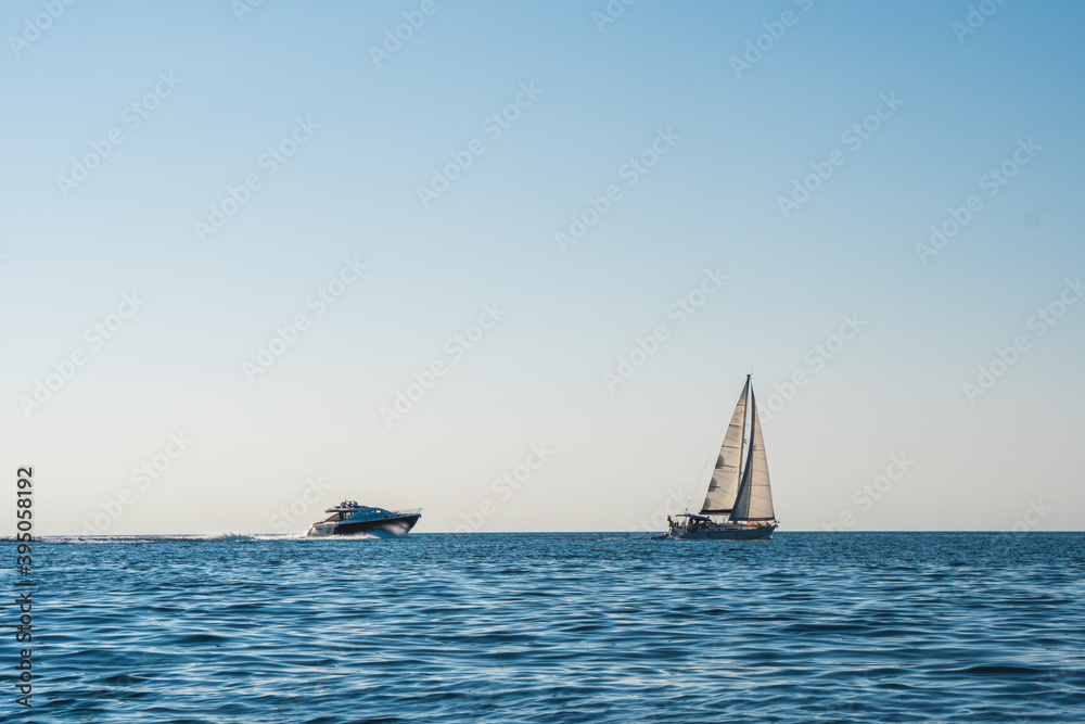 Beautiful view of the sunset over the Adriatic sea, boat sailing at the horizon. Tranquil relaxing atmosphere