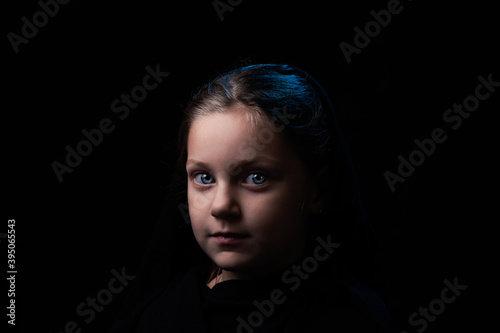 head shot of a cute little girl on a black backround