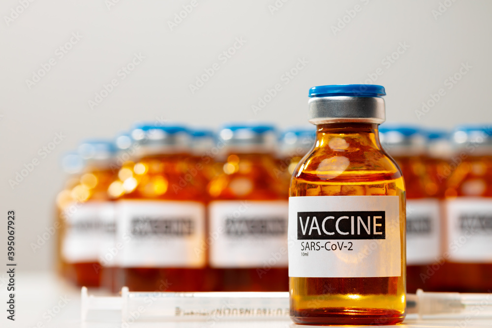 Sars-cov-2 vaccine vial bottles on white table Sars-cov-2 vaccine vial bottles on white table
