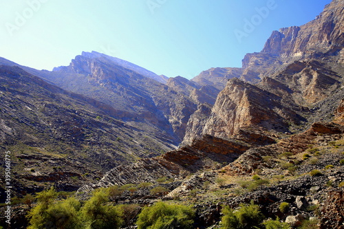 Mountains with unidirectional rocks fractures and grass area, Wadi Bani Awf, Al Rustaq, South Batinah Governorate of Oman