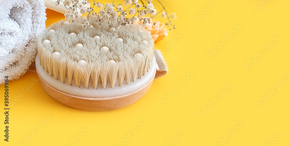 massage brush, soap on a colored background massage brush, soap on a colored background