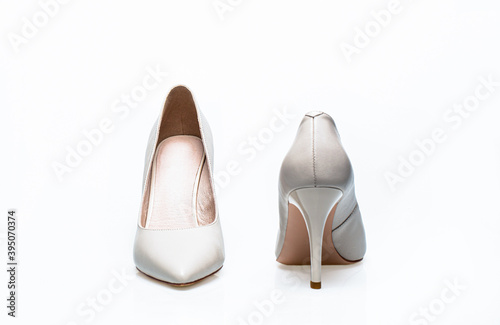 White high heel women shoes on white background. White shoe for women. Beauty and fashion concept. Fashionable women shoes isolated on white background. Stylish classic women leather shoe photo