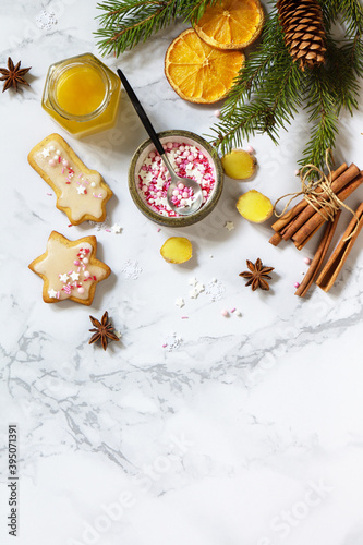 The gingerbread Christmas baking seasoning is honey, cinnamon, anise and ginger on a marble countertop. Seasonal, food background. Flat top view. Copy space.