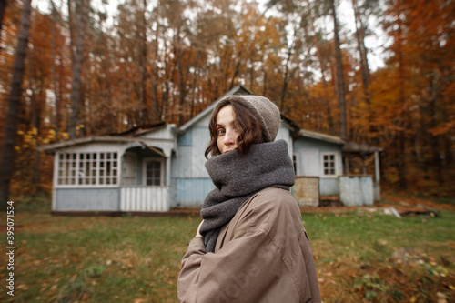 young woman in the autumn forest near the old house