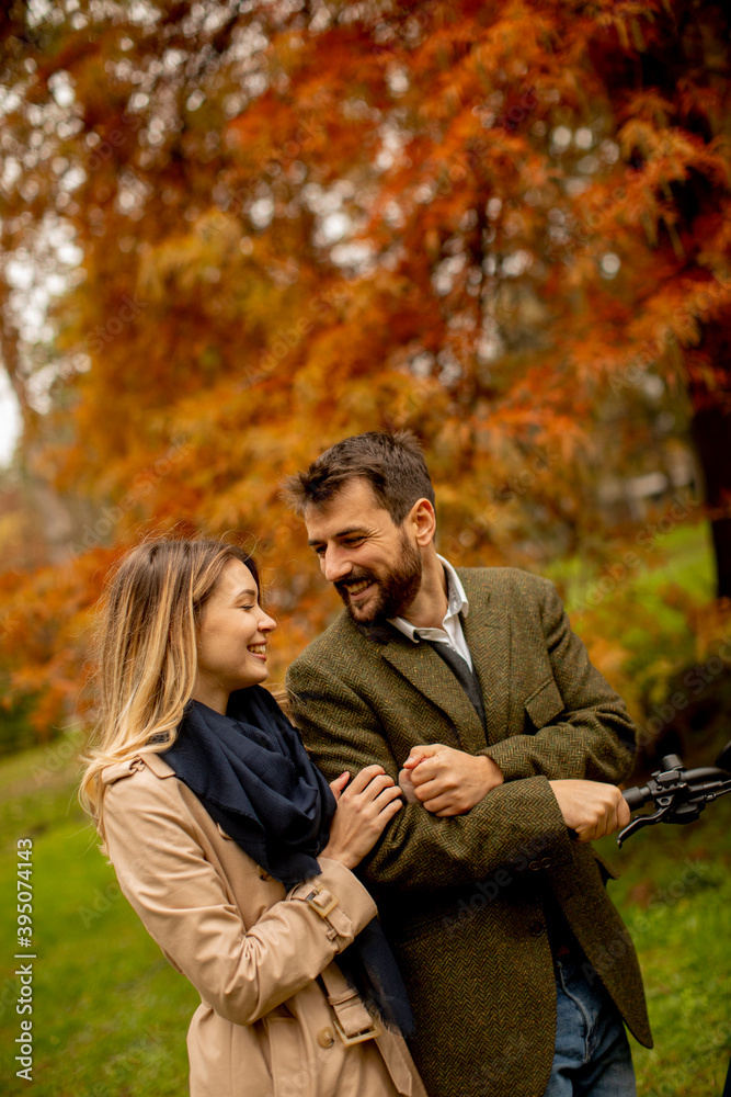 Young couple walking in the autumn park
