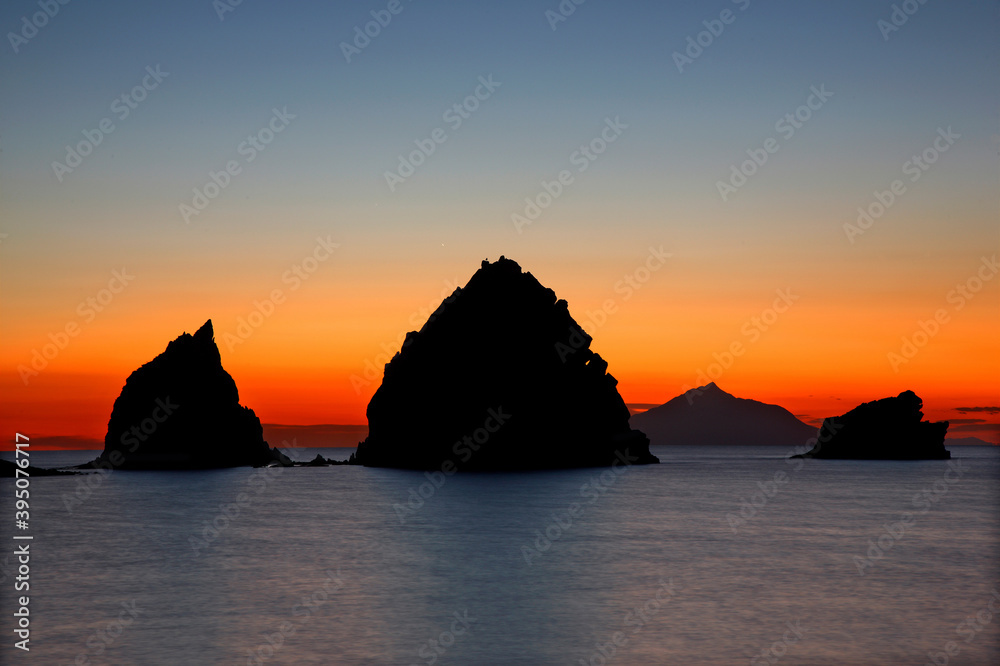 LEMNOS ISLAND,  NORTH AEGEAN, GREECE.  Sunset at Avlonas beach, very close to Myrina, the capital town of the island. The little volcanic islets are called 