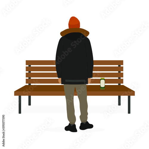 A male character stands with his back near a bench and a beer can stands on the bench