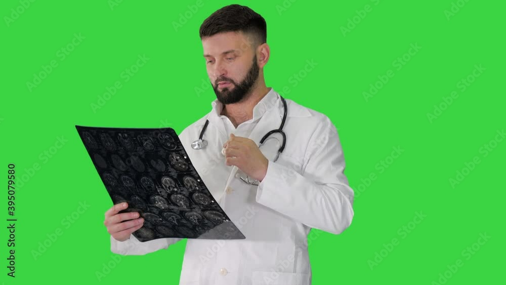 Physician reading and reviewing a MRI brain scan on a Green Screen, Chroma Key. Physician reading and reviewing a MRI brain scan on a Green Screen, Chroma Key.
