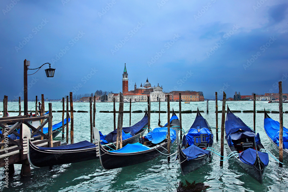 Gondolas in front of San Marco square, Venice, Italy. In the background, San Giorgio Maggiore.
