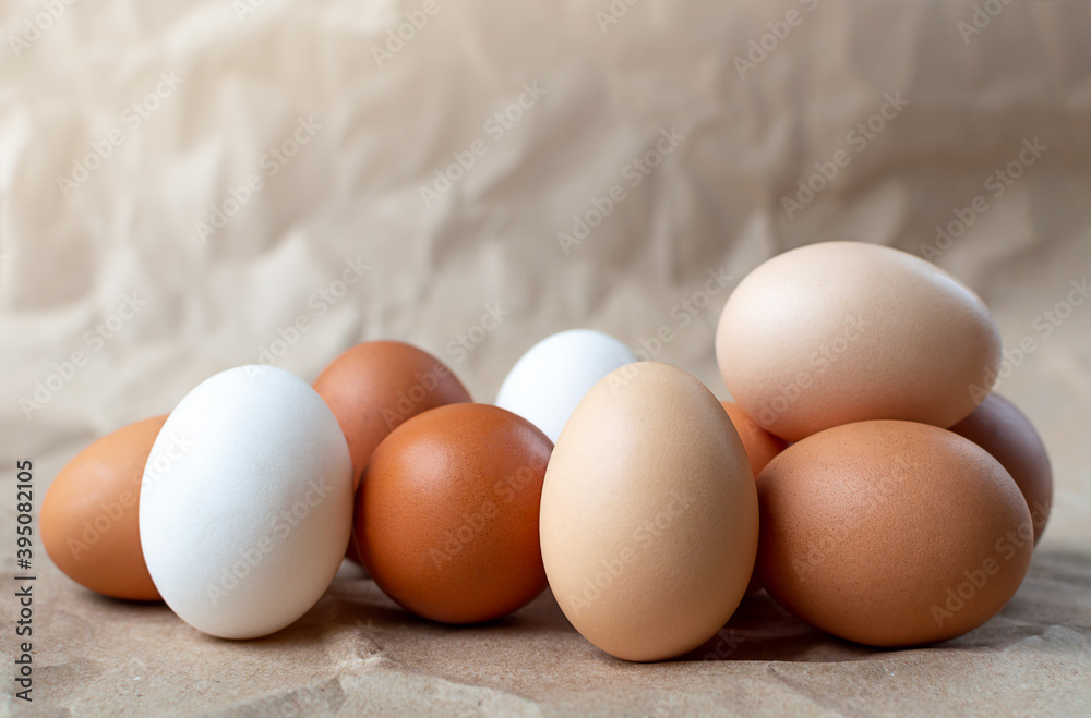 Many different eggs on a craft paper background with copy space Many different eggs on a craft paper background with copy space