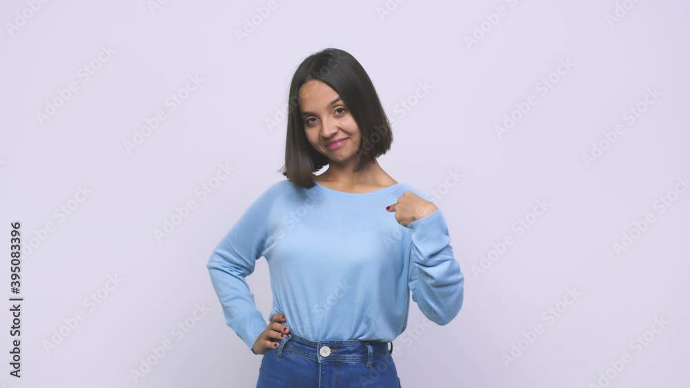Young mixed race woman person pointing by hand to a shirt copy space, proud and confident Young mixed race woman person pointing by hand to a shirt copy space, proud and confident