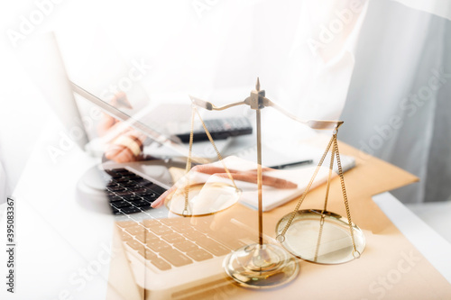 justice and law concept.Male judge in a courtroom on wooden table and Counselor or Male lawyer working in office. Legal law, advice and justice concept. © ARMMY PICCA