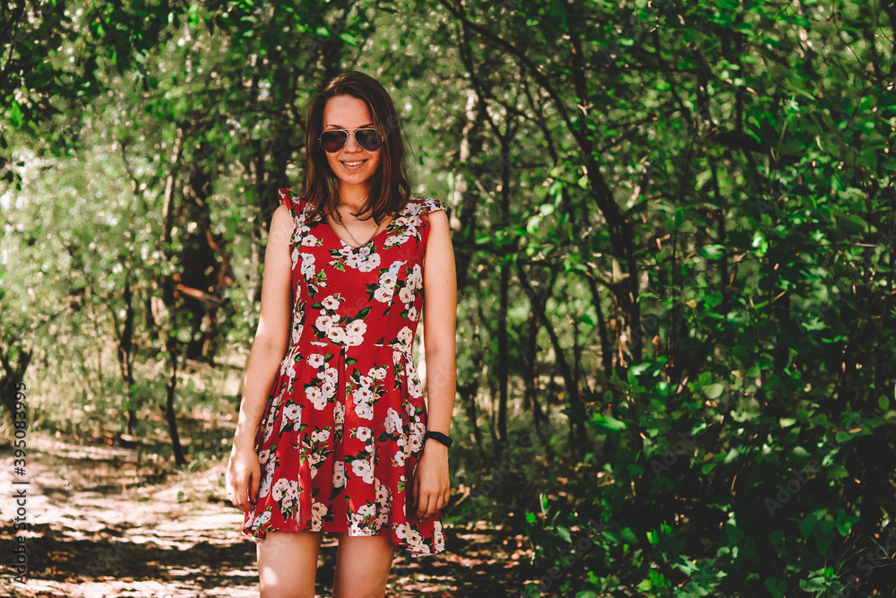 girl in a red dress dances on the shore on the background of the floodplain girl in a red dress dances on the shore on the background of the floodplain