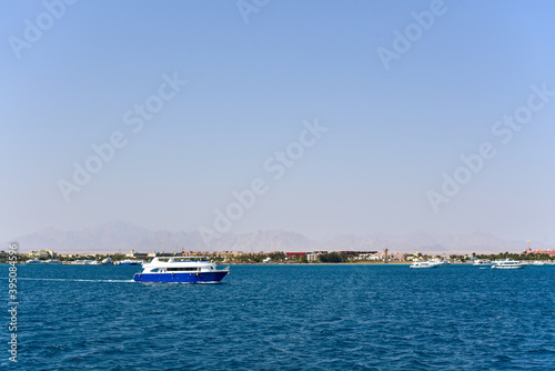 The yacht sails on the sea along the coast in Africa © AliaksandrBS
