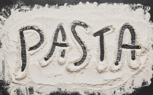 Pasta sign with flour Artwork With Food And Handprints, Fun background with human handpints in scattered flour on the dark background. Copy space