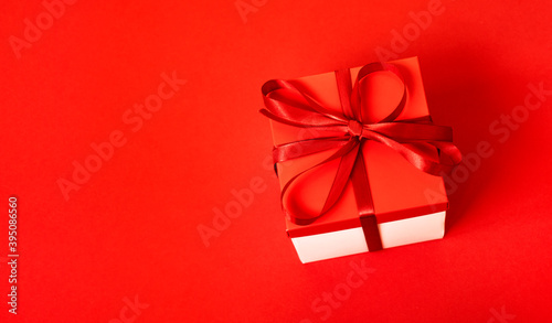 Gift box with a cones on a red background. Christmas background. Top view. Space for text.