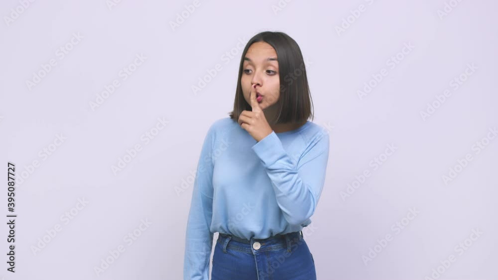 Young mixed race woman keeping a secret or asking for silence Young mixed race woman keeping a secret or asking for silence