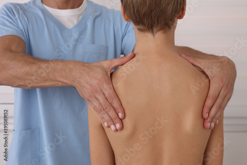 Physiotherapist exam for teenage boy. Manual Muscles Tests and Posture Checking . Preventive Health Care Visits in Children