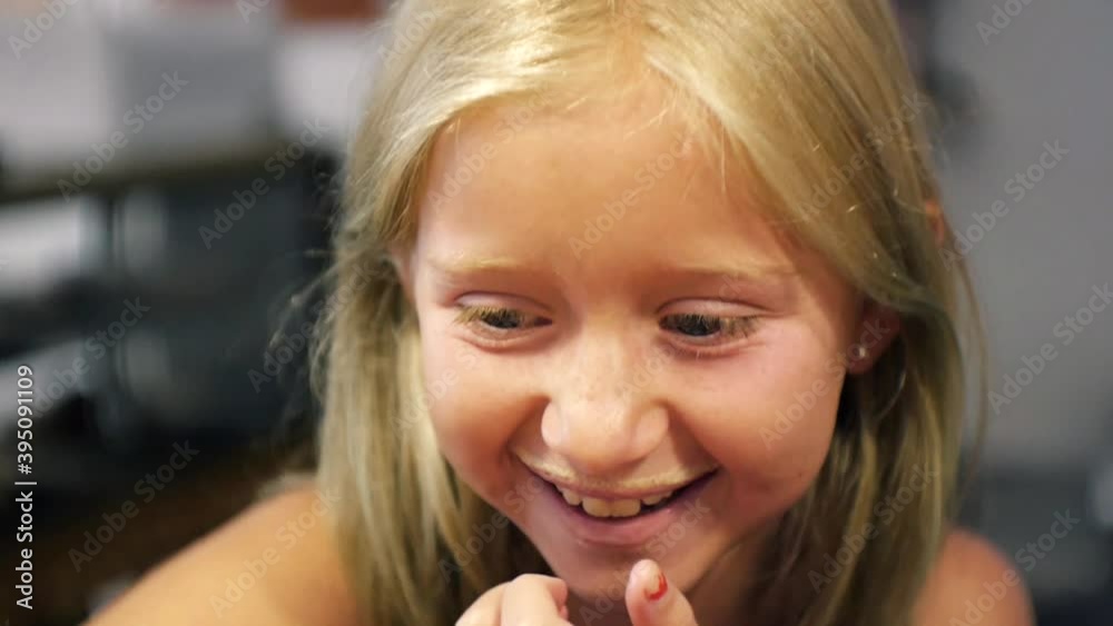 Young girl with milk mustache on the upper lip laughing. Close-up. Young girl with milk mustache on the upper lip laughing. Close-up.