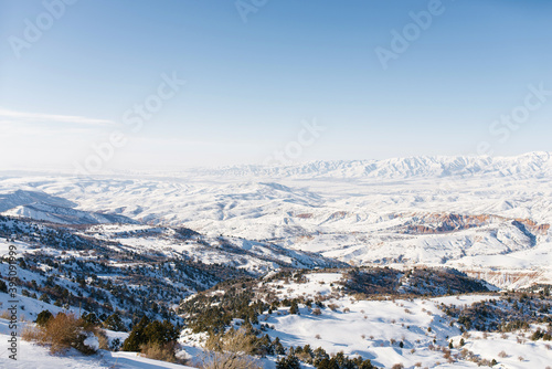 Crazy winter panorama of the Tien Shan mountains in Uzbekistan in Beldersay ski resort on a clear winter day