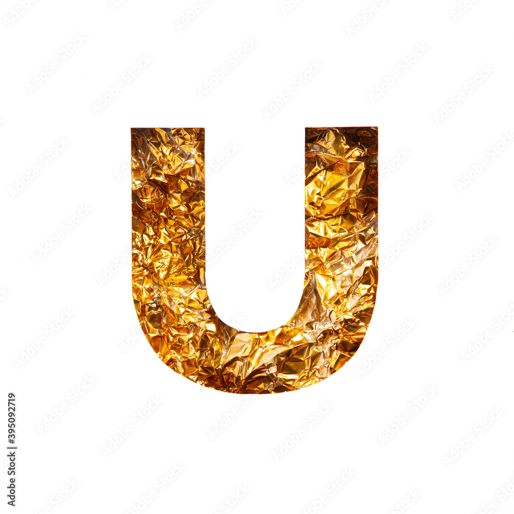 Gold letter U of English alphabet of glittering crumpled foil and paper cut isolated on white. Festive golden typeface Gold letter U of English alphabet of glittering crumpled foil and paper cut isolated on white. Festive golden typeface