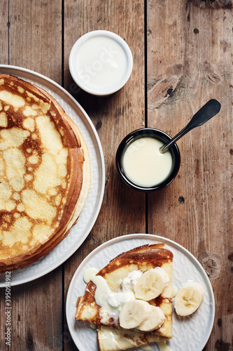 Thin pancakes, crepes with bananas and condensed milk.