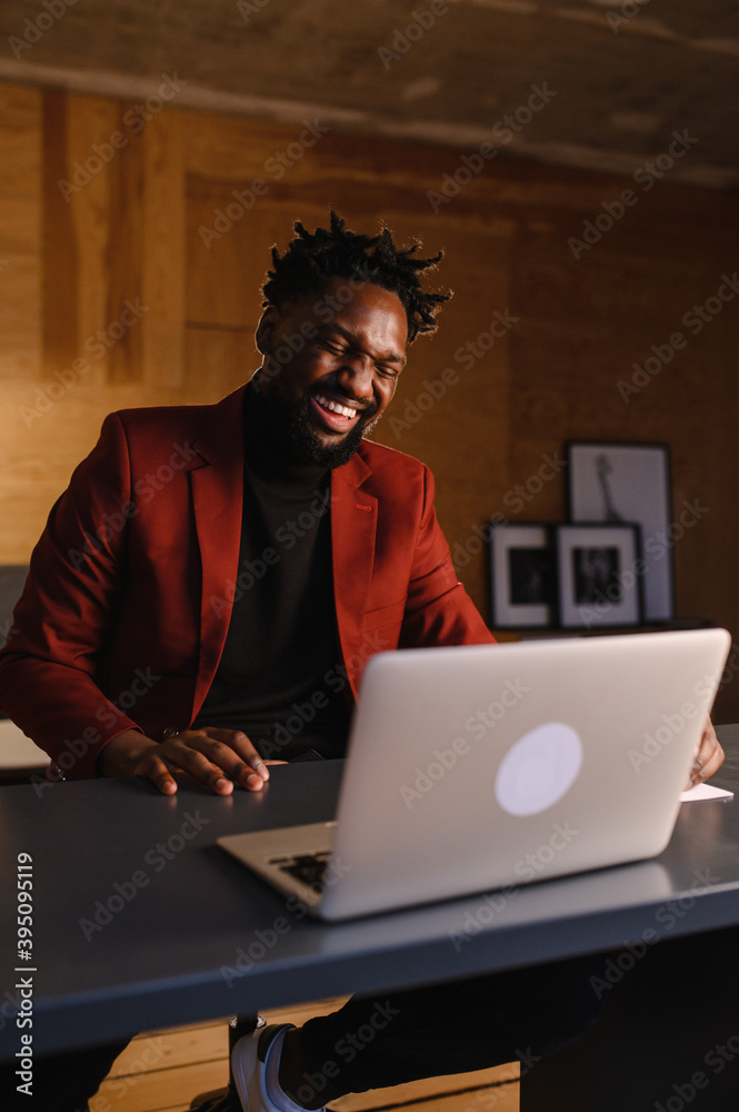 Black Businessman using laptop for analyzing data stock market, forex trading graph, stock exchange trading online, financial investment concept. close up Black Businessman using laptop for analyzing data stock market, forex trading graph, stock exchange trading online, financial investment concept. close up