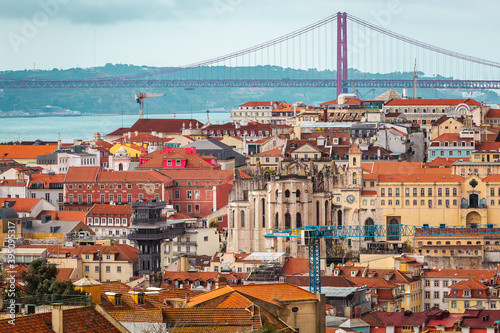 view over the capital of Portugal Lisbon Lisboa colorful buildings with mostly orange roofs Ponte 25 de Abril
