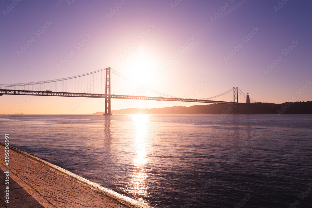 Ponte 25 de Abril Lisboa Lisbon Portugal bridge and Sanctuary of Christ the King, Santuário de Cristo Rei in the morning sunrise over Tagus river Ponte 25 de Abril Lisboa Lisbon Portugal bridge and Sanctuary of Christ the King, Santuário de Cristo Rei in the morning sunrise over Tagus river
