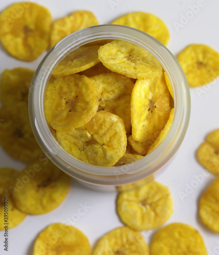 A jar full of dried banana chips a delicacy of South Indian states Healthy sweet snack, crispy dehydrated unsweetened banana chips in colorful glass jar