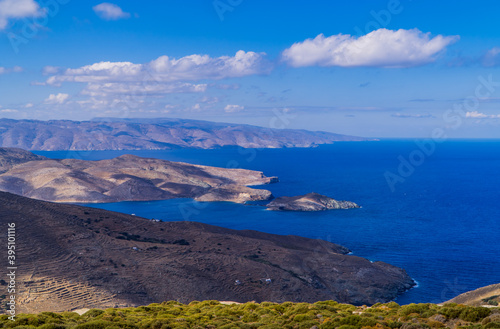 Coastal landscapes on the island of Tinos, Cyclades, Greece with the island of Andros in the background