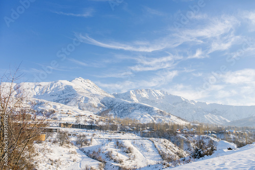 Beautiful winter in the mountains with snow. Winter Paradise in Central Asia with frosty conditions. Uzbekistan, not far from the Chimgan mountains in the cold and snowy winter.