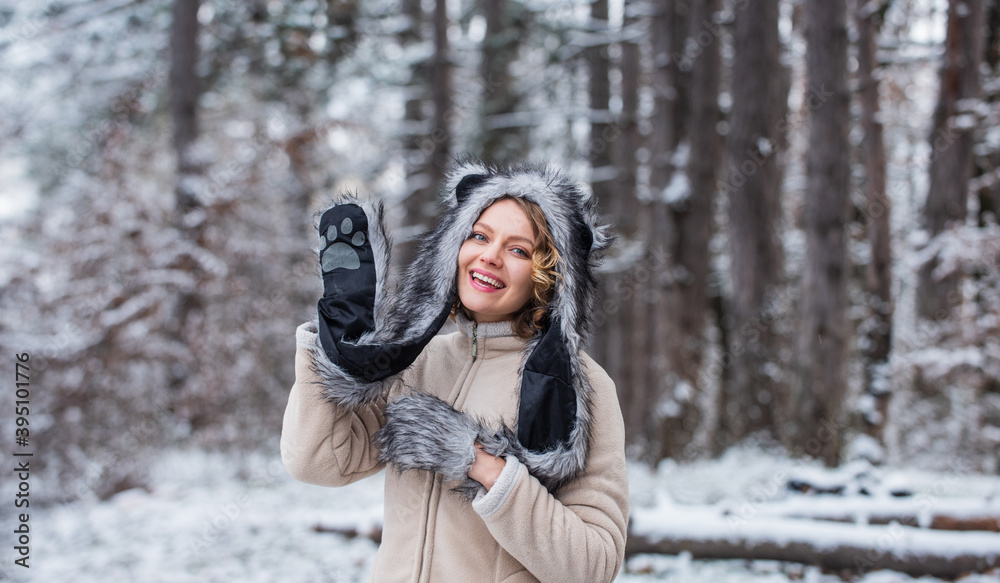 Heartwarming concept. Animal care. Winter themed portrait cosy outfit. Woman wear wolf hat. Animal rights. Wild life symbol. Girl in snowy forest. Faux fur animal hat perfect for fantasy theme Heartwarming concept. Animal care. Winter themed portrait cosy outfit. Woman wear wolf hat. Animal rights. Wild life symbol. Girl in snowy forest. Faux fur animal hat perfect for fantasy theme