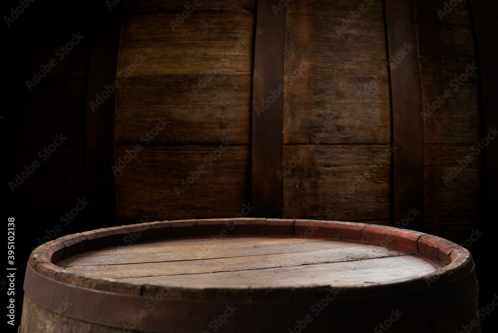 Fototapeta premium Old wooden barrel on a brown background