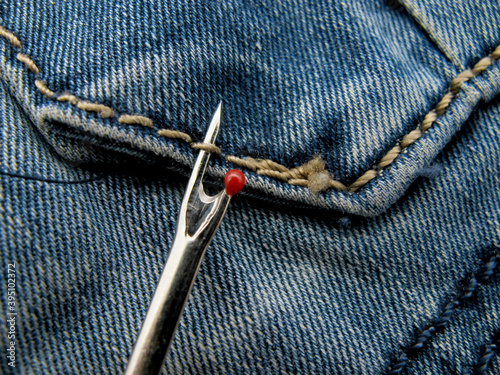 The process of ripping threads on jeans with a special tool Ripper.