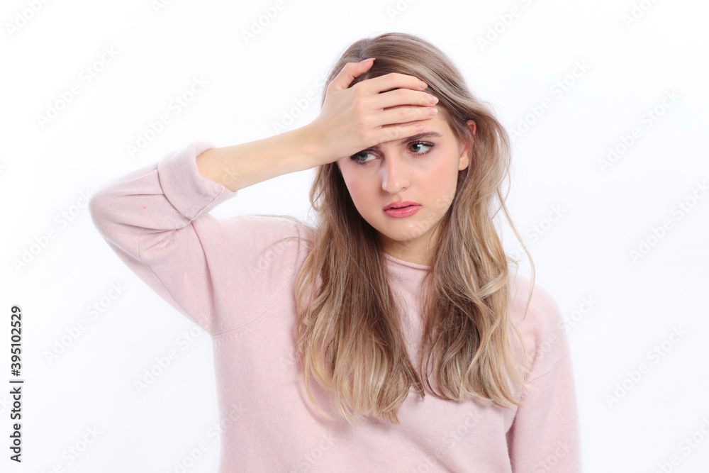 Woman holds her hand at her forehead isolated Woman holds her hand at her forehead isolated