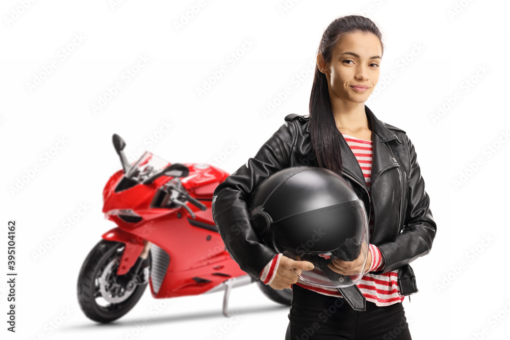 Young female motorcyclist with a ride bike holding a helmet Young female motorcyclist with a ride bike holding a helmet
