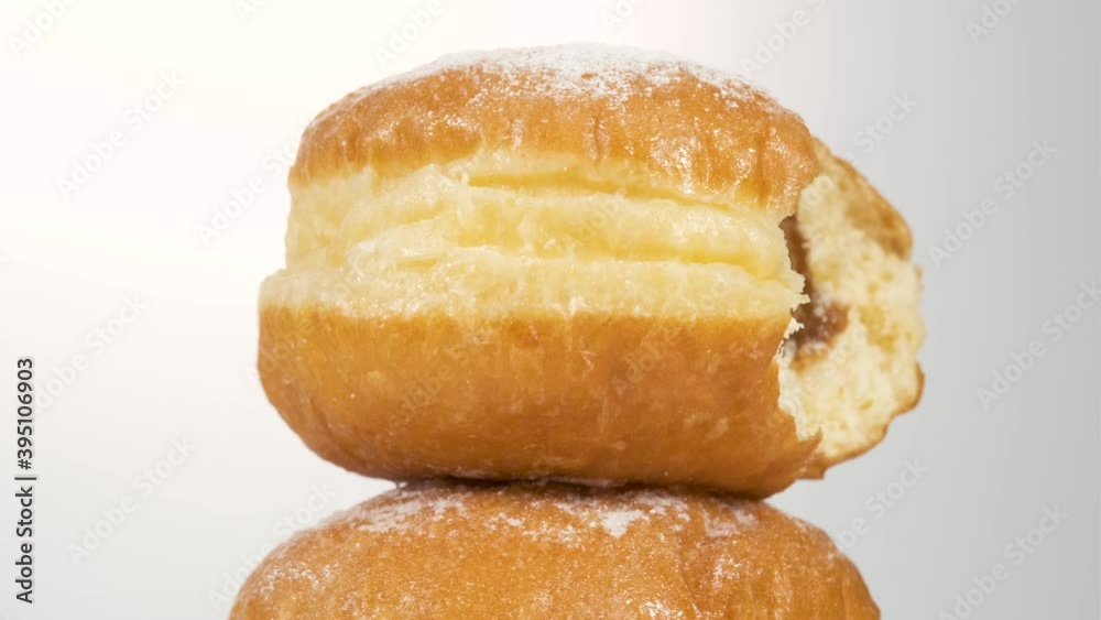 Doughnuts with boiled condensed milk on a white background, donut bite mark. Delicious sweet donut rotating. Doughnuts with boiled condensed milk on a white background, donut bite mark. Delicious sweet donut rotating.