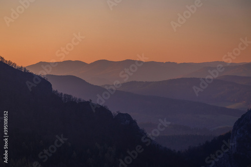 Mountains colored at sunset in autumn..The ridges of the mountains are condensed from the perspective of a telephoto lens.