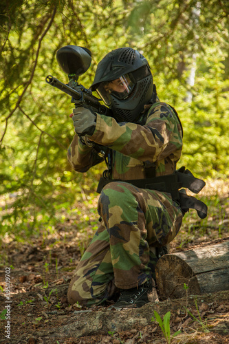 boy with paintball gear in forest