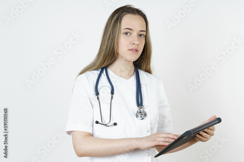 Medicine and health concept. The doctor writes the information into the tablet.