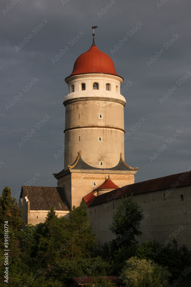Domed Renaissance city wall tower of Löpsinger Tor gate in the old medieval town of Nördlingen in the evening sun, Germany